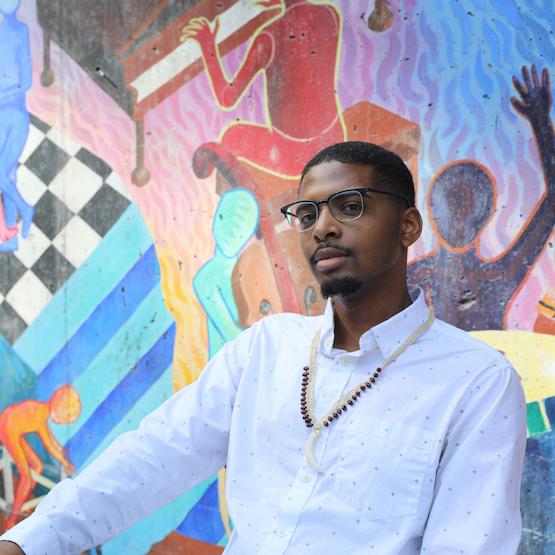Student with mural in the background